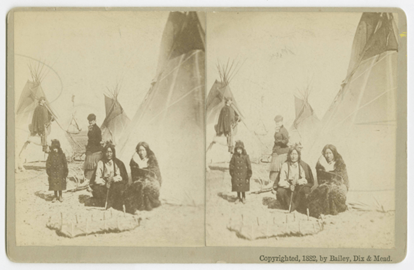 One Bull and Prairie Chicken outside a tent.