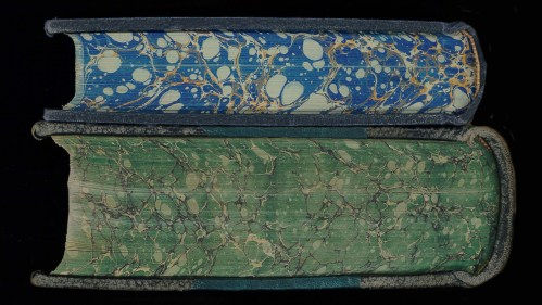 Two books showing marbling along bottom edge of the text blocks. 