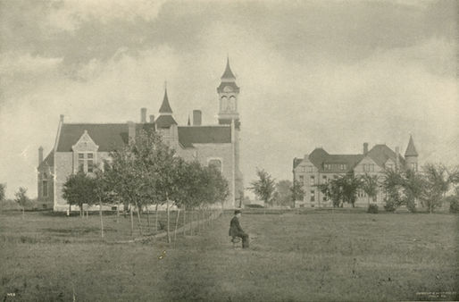 A man sitting by himself outside of Old Main.