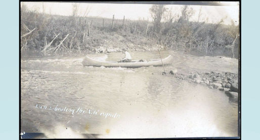 Photograph postcard showing man in canoe on Vermillion River.