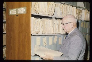 Herbert Schell reviewing files in the university archives.