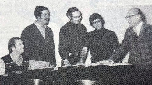 Photograph from newspaper of five men.