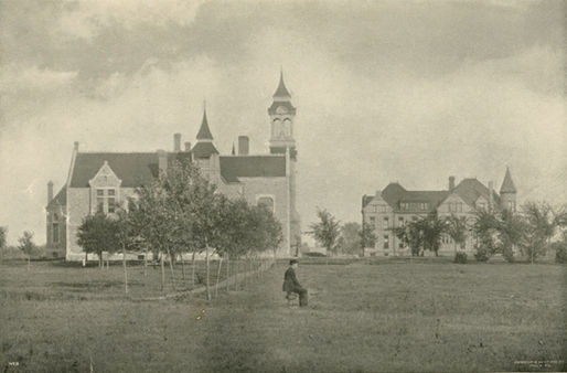 A man sitting by himself outside of Old Main.